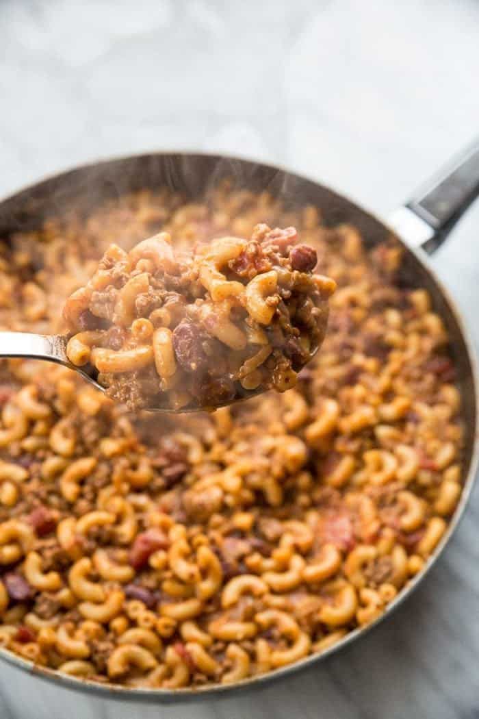 Spoon of Homemade Cheesy Chili Mac Skillet with Ketchup