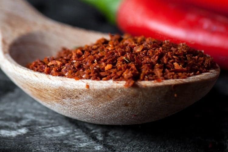 close up Homemade Chili Seasoning in a wooden spoon