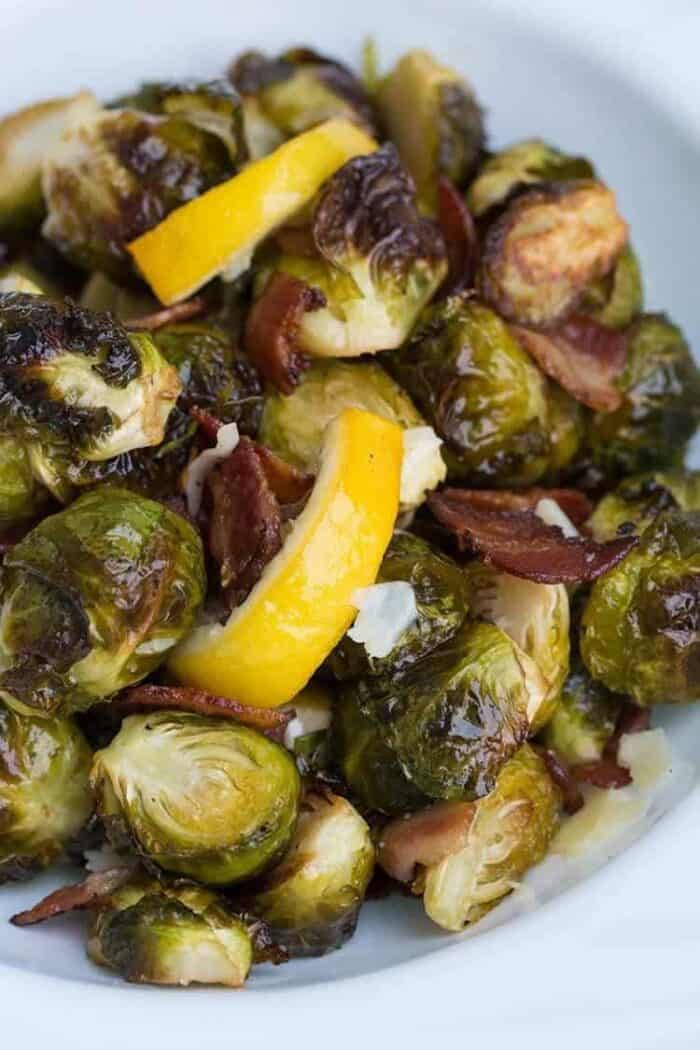 Close up of Crispy Lemon Bacon Roasted Brussels Sprouts in white bowl