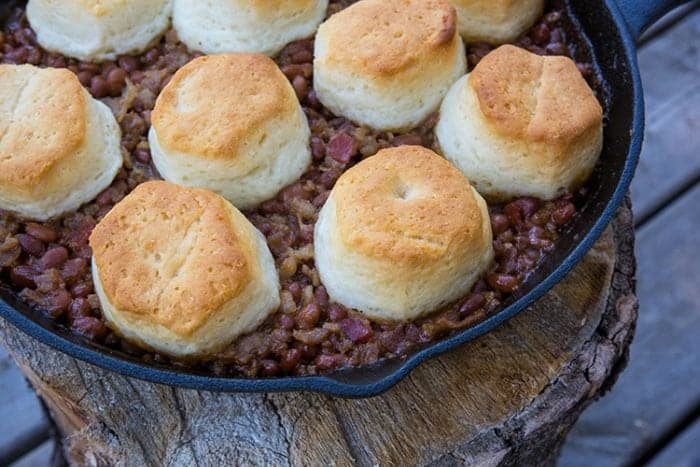 Pork & Beans Cowboy Casserole iron skillet with biscuits on top