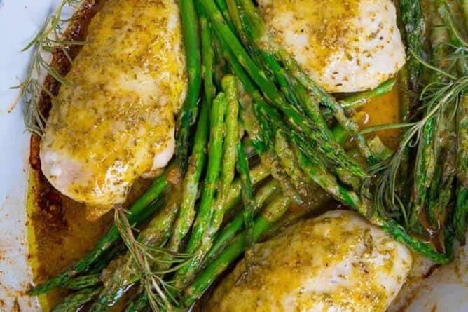 Top down shot of Lemon Chicken with Rosemary & Asparagus in white pan