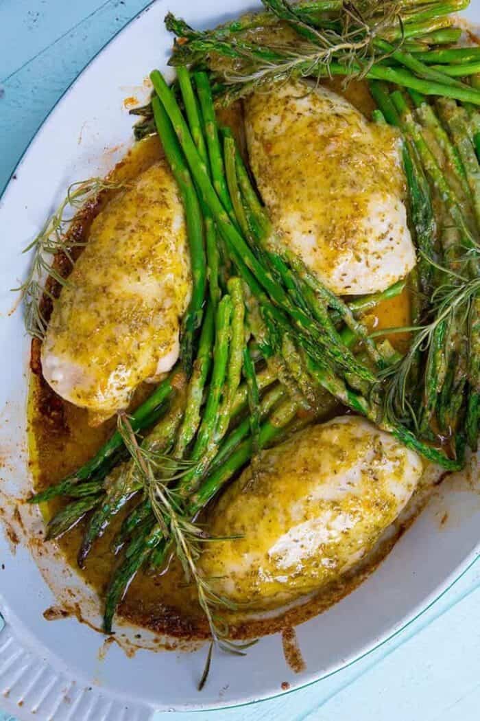 Top down shot of Lemon Chicken with Rosemary & Asparagus in white pan ready to be enjoy!