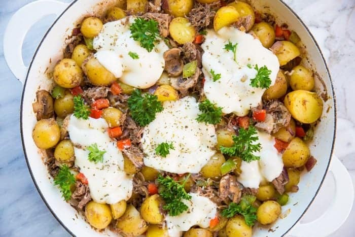 Cheesy Italian Beef Breakfast Skillet topped with mozza circles and fresh parsley