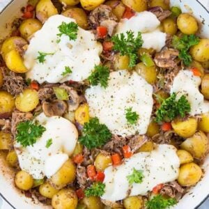 top down shot of Cheesy Italian Beef Breakfast Skillet in a marble background