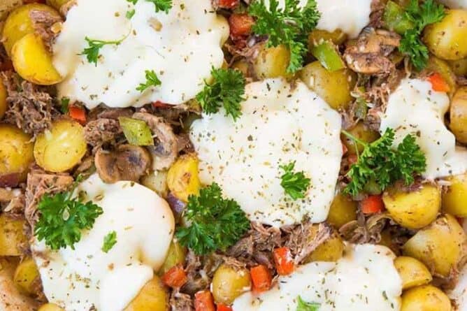 top down shot of Cheesy Italian Beef Breakfast Skillet in a marble background
