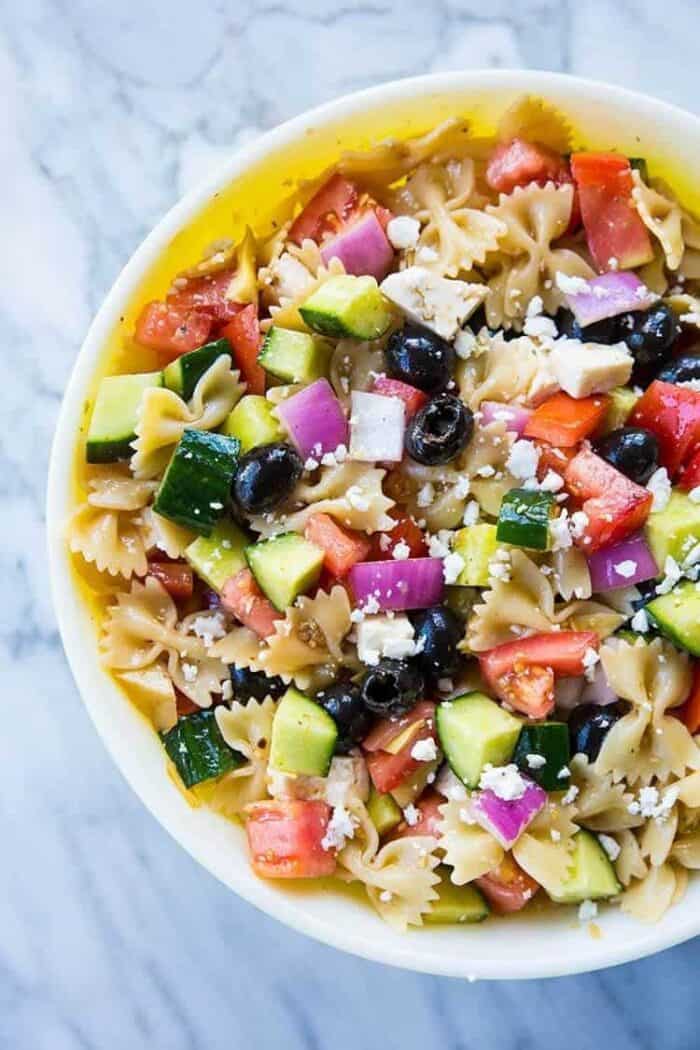 close up Greek Pasta Salad, loaded with mixed olives, cucumber and artichoke
