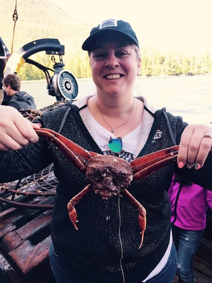 lady holding a live crab for the purpose of pictures