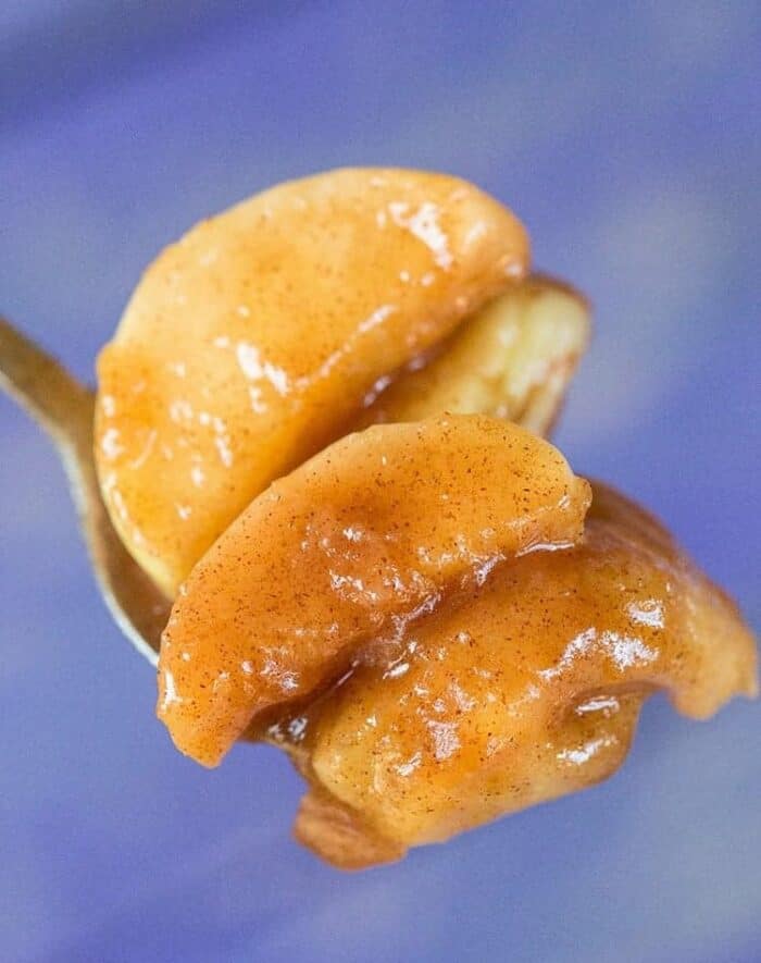 slices of Fried Apples with sauce in a spoon