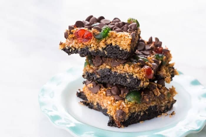 stack of Christmas Magic Bars in a white dessert plate