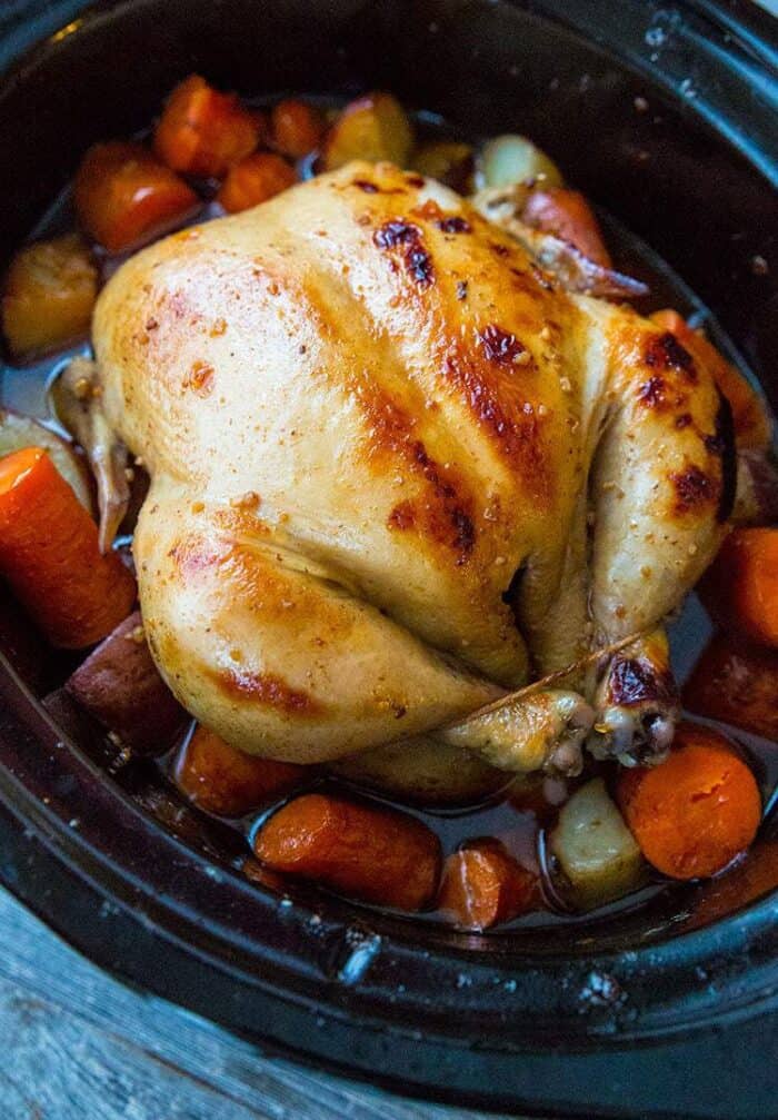 whole chicken in a crockpot with carrots and potatoes