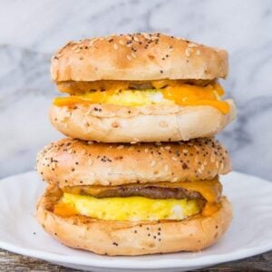 close up Sausage & Egg Breakfast Bagels in a white plate on a marble background