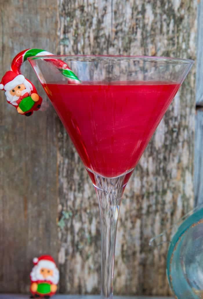 close up Santa Baby Cocktail with Santa and candy cane decoration in a martini glass