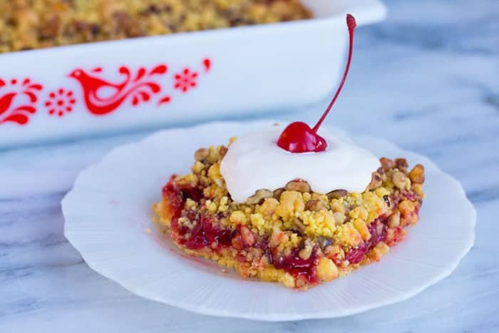 a slice of Lemon Cherry Crunch Cake in a white plate