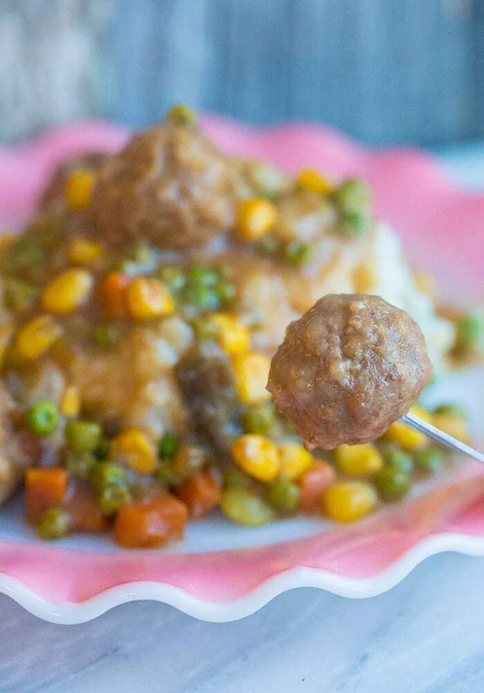 a Meatball in a fork from a plate of Shepherd's Pie