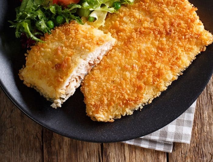 Zesty Ranch Air Fryer Fish Fillets in black serving plate garnish with some leafy vegetables