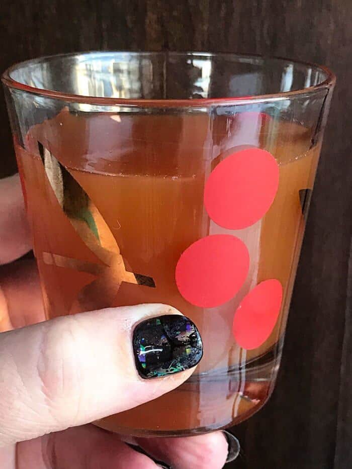 holding a Cherries vintage glass with Alabama Slammer Cocktail