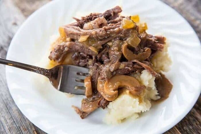 Beer & Mushroom Instant Pot Pot Roast on white plate with mashed potatoes