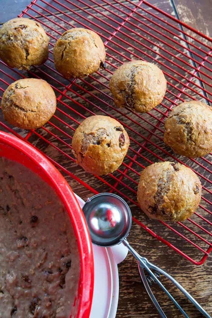 Cinnamon Raisin Oat Bran Mixture in Red Bowl and Muffins in red cooling rack