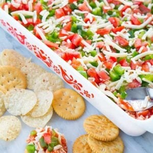 Shrimp Dip in white Pyrex baking pan and in chips and crackers