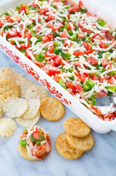 Shrimp Dip in white Pyrex baking pan and in chips and crackers
