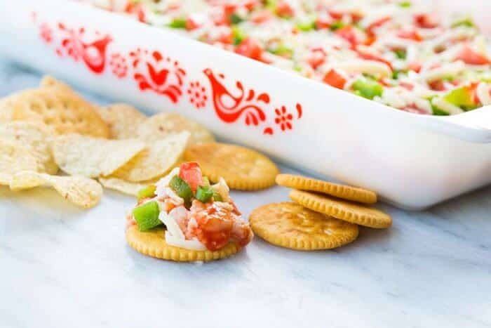 Shrimp Dip in white Pyrex baking pan and in chips and crackers 