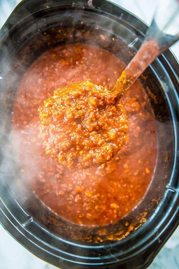 a scoop of Bolognese Sauce from slow cooker