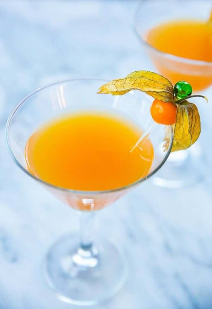Close up of Bronx Cocktail in Martini Glass Garnish with Gooseberry