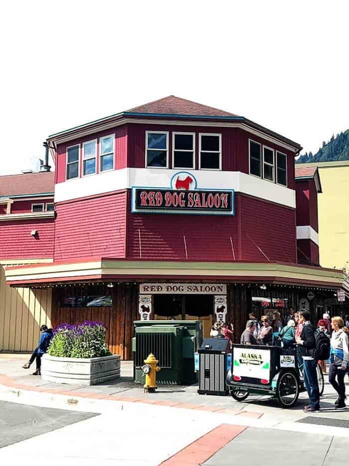 Red Dog Saloon - red colored building with logo of dog