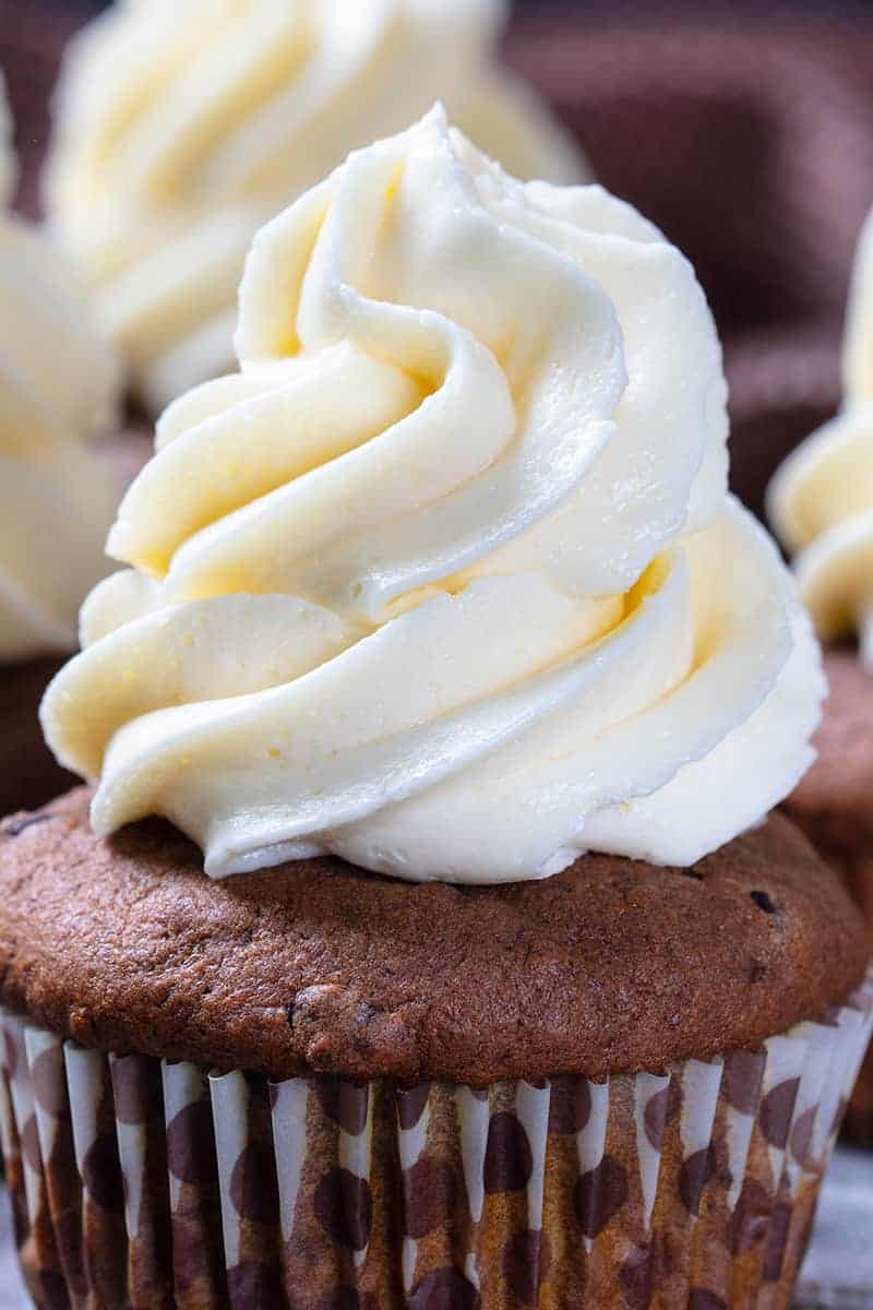 close up of buttercream icing swirl on a chocolate cupcake