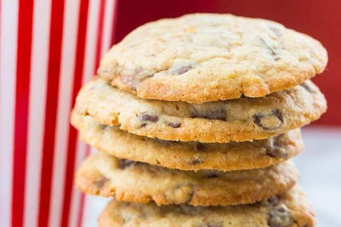 Close up Stack of DoubleTree Hotel Chocolate Chip Cookies, tall stripe red tumbler at the back