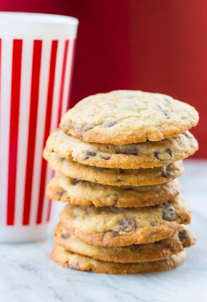 Close up Stack of DoubleTree Hotel Chocolate Chip Cookies, tall stripe red tumbler at the back