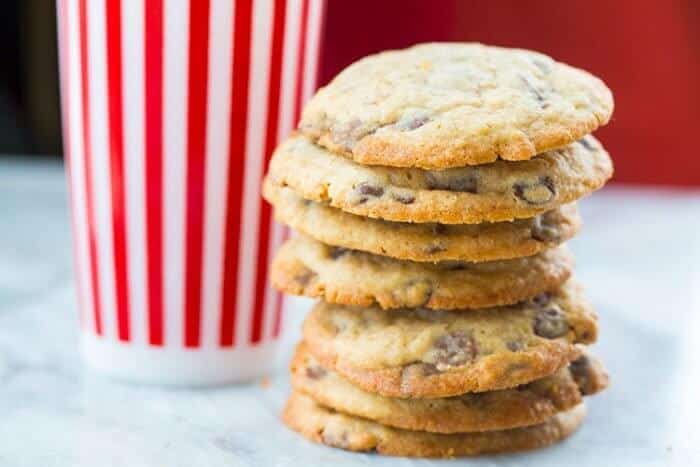 Stack of DoubleTree Hotel Chocolate Chip Cookies, tall stripe red tumbler at the back