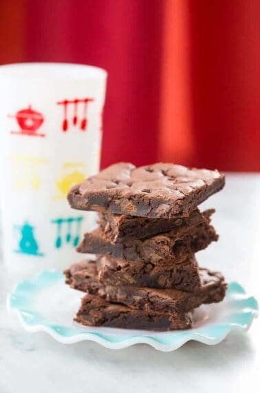 stack of Cake Mix Cookie bars in a blue plate on red background