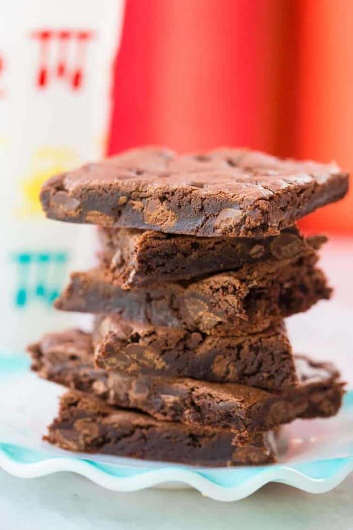 stack of Cake Mix Cookie bars in a blue plate on red background