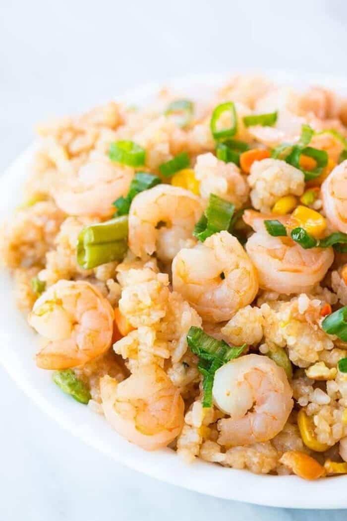 Shrimp Fried Rice in a white bowl topped with chopped green onions