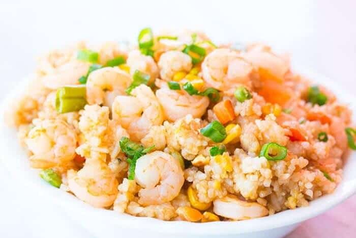 white bowl with Easy Shrimp Fried Rice topped with chopped green onions