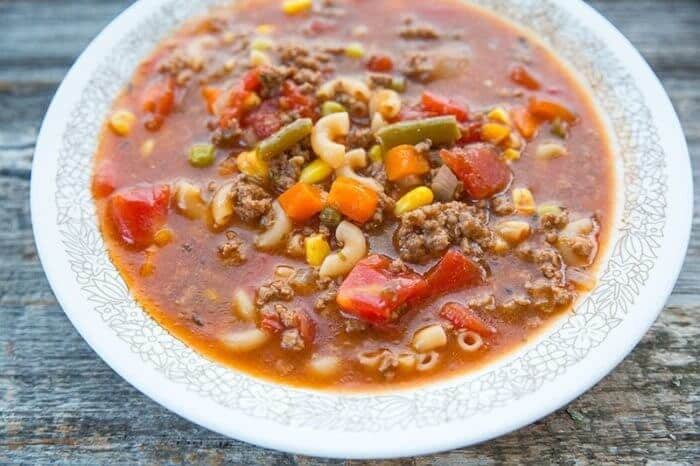 Hamburger Soup With Elbow Macaroni and Vegetables in a Soup Bowl on Wood Background