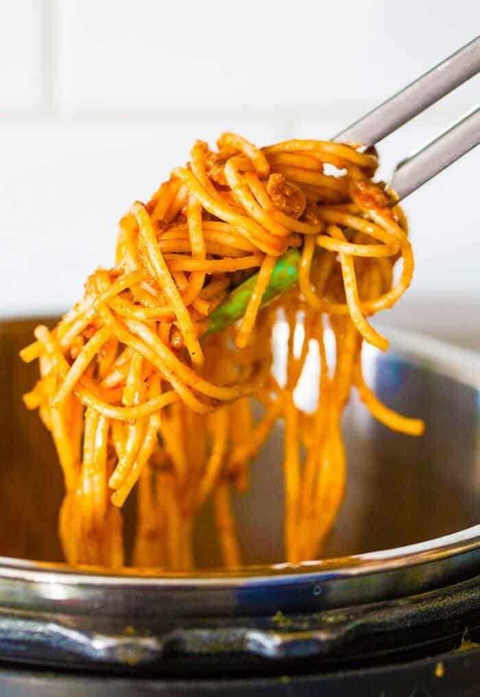 getting some instant pot spaghetti using kitchen tongs