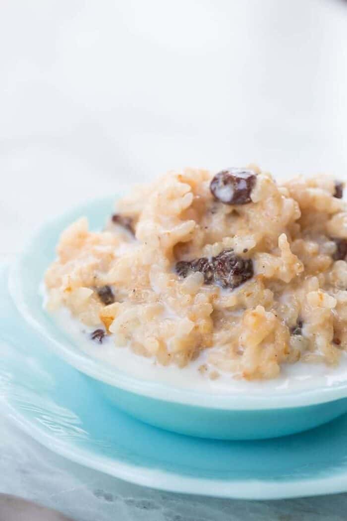 Close up of Instant Pot Rice Pudding in a Jade blue bowl 