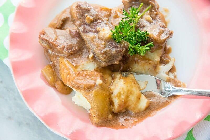 Mushroom Crock Pot Cube Steak & Gravy in a pink plate