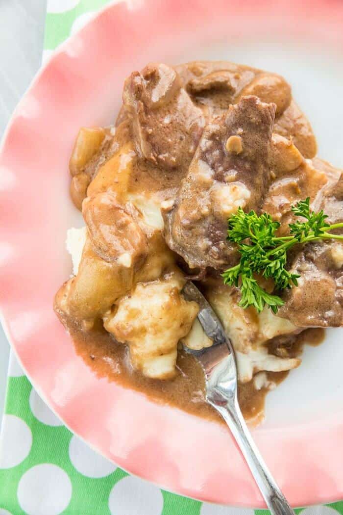 Crockpot Cube Steak served with potatoes in a pink plate