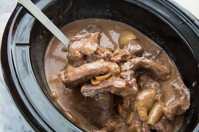  Mushroom Crockpot Cube Steak & Gravy in a black crockpot