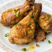 Plate with Baked Chicken Legs with Salt & Pepper and garlic oil on top
