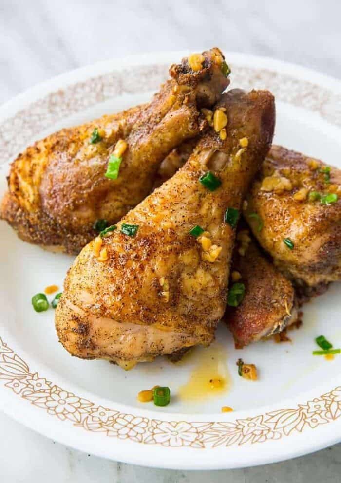 Plate with Crispy Baked Chicken Legs with garlic oil on top