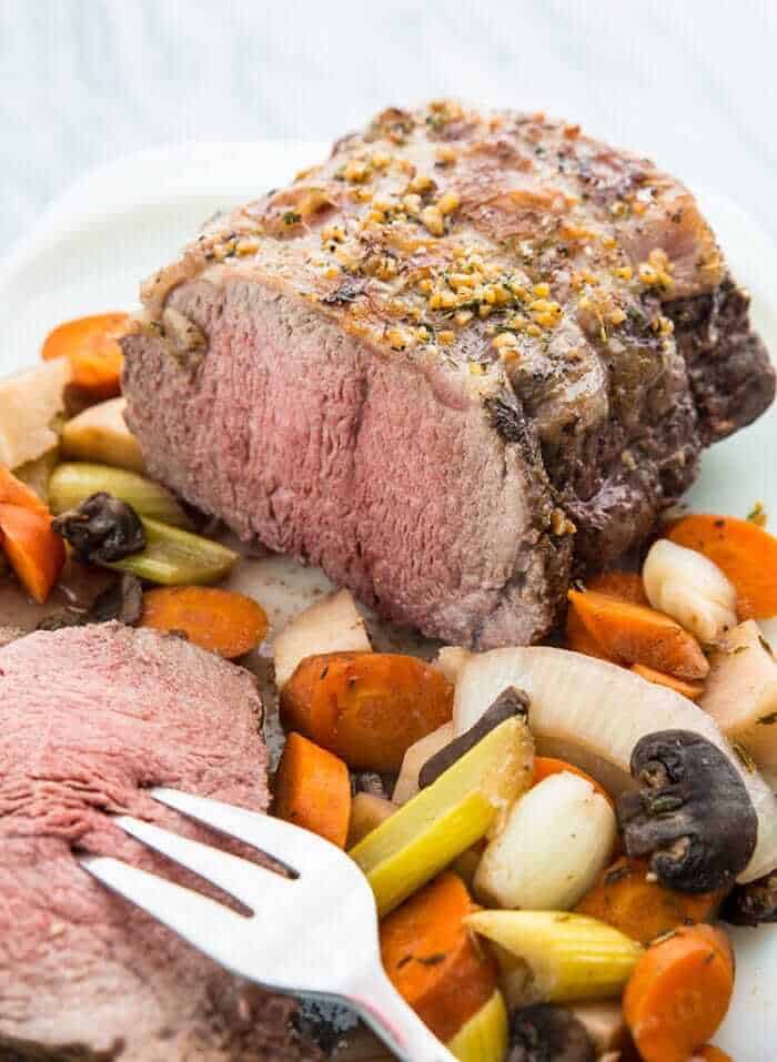 Sliced Slow Cooker Striploin Roast Beef Served with Vegetables and Gravy