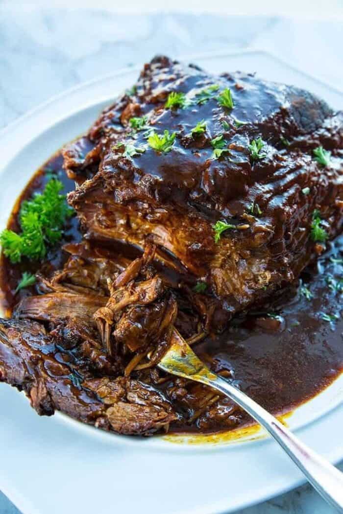 using a fork to get some Slow Cooker Brisket with root beer and BBQ sauce