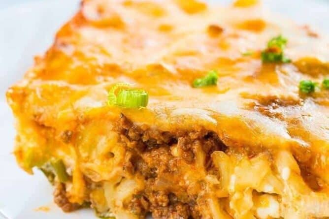 Slice of Sour Cream Ground Beef Noodle Casserole in a White Plate