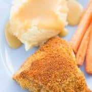 a piece of Crispy Oven Baked Chicken Thigh served with a scoop of mashed potato with gravy