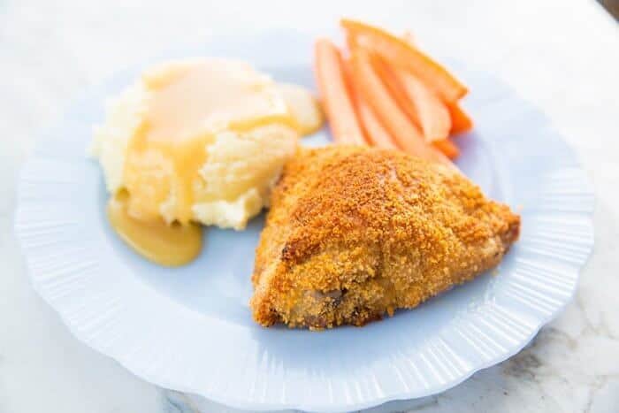 Tender, Crispy Oven Baked Chicken Thigh in a white plate