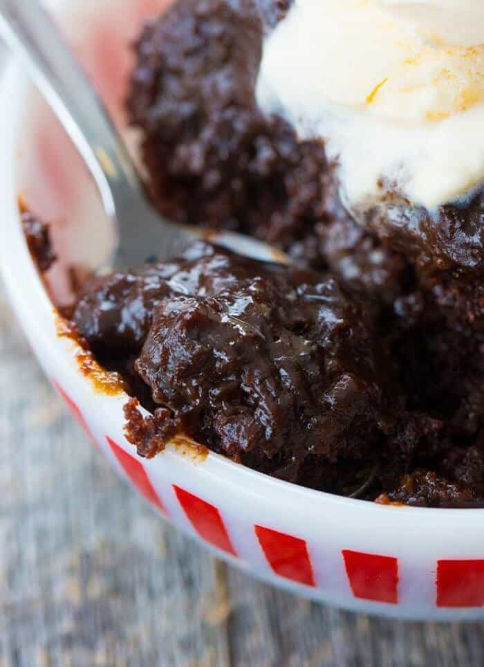  Close up spooning the Chocolate Lava Cake with vanilla ice cream on top